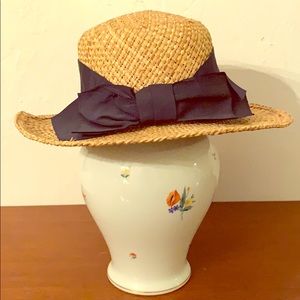 Woven straw sun hat with oversized bow.